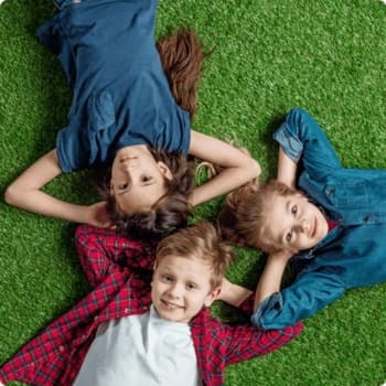 kids laying on the grass