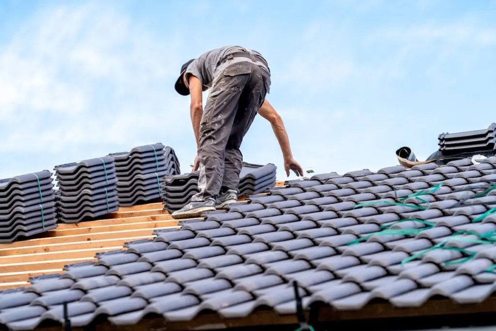 craftsman installs ceramic tile roofing.