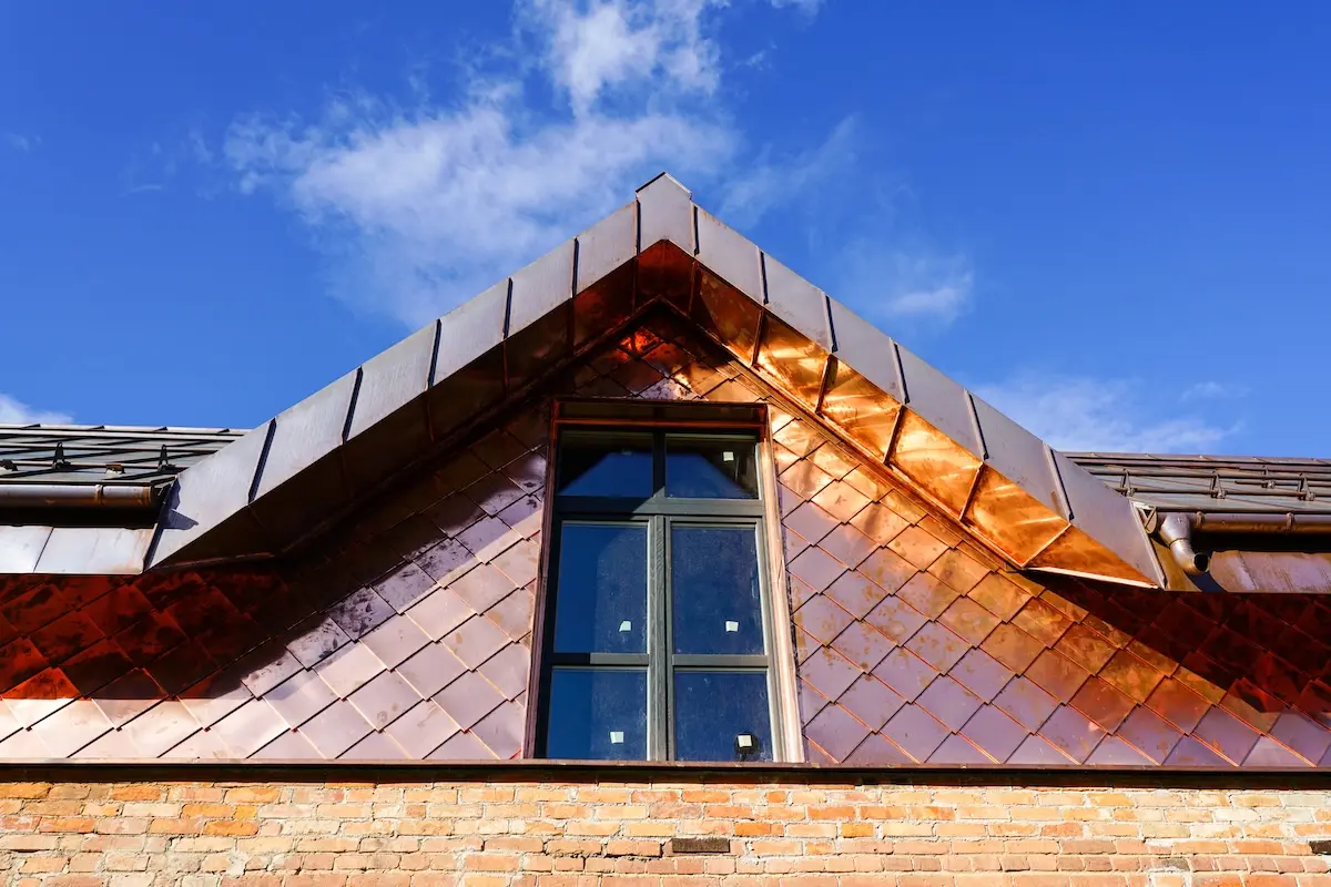 a fragment of a house facade lined with copper plates