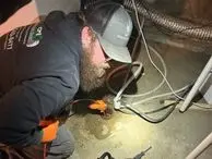 guy inspecting drain using camera