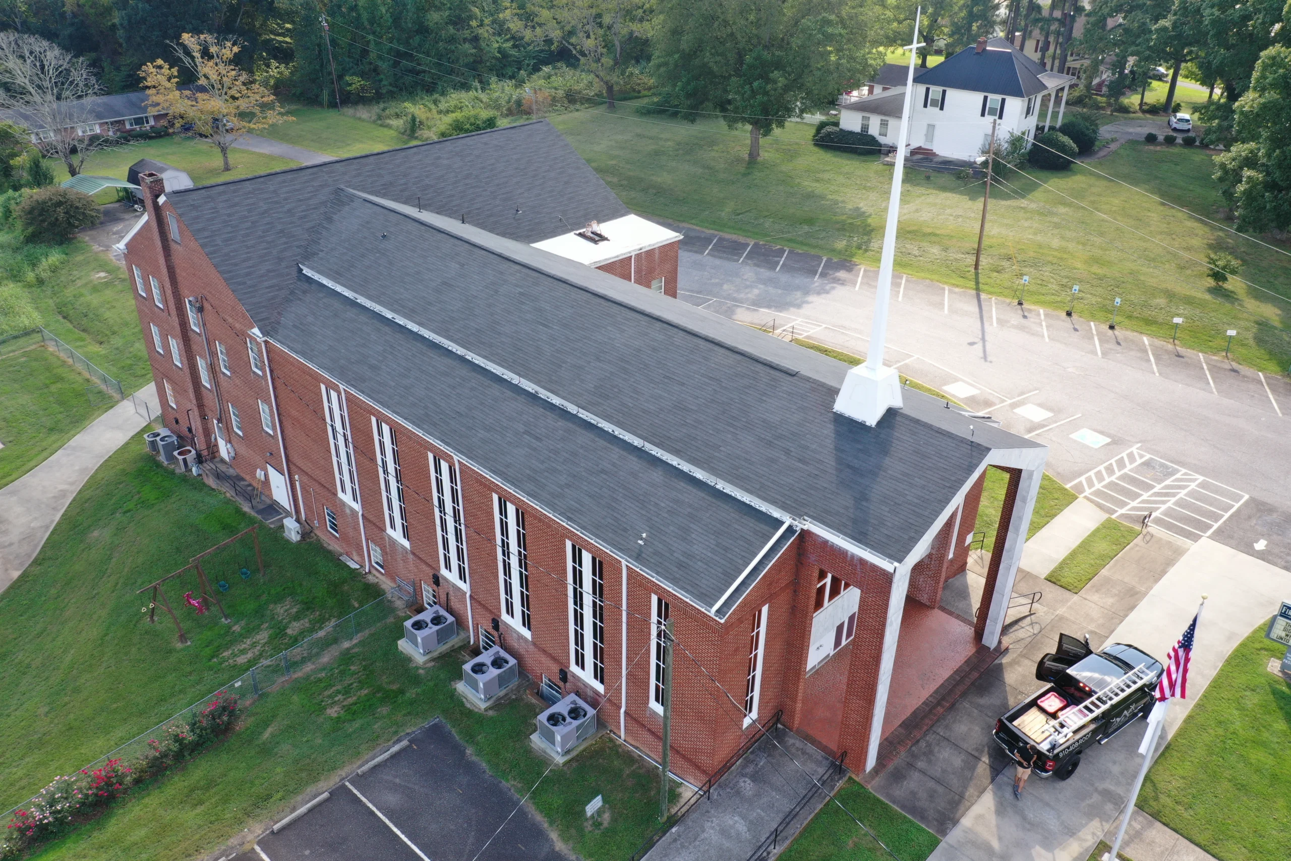 replaced asphalt shingle roof of large building