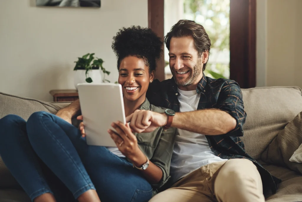 couple looking at laptop at home