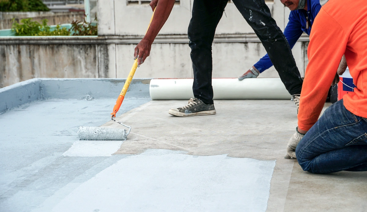 three people roof coating