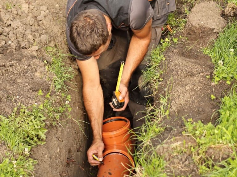 guy repairing orange sewer line