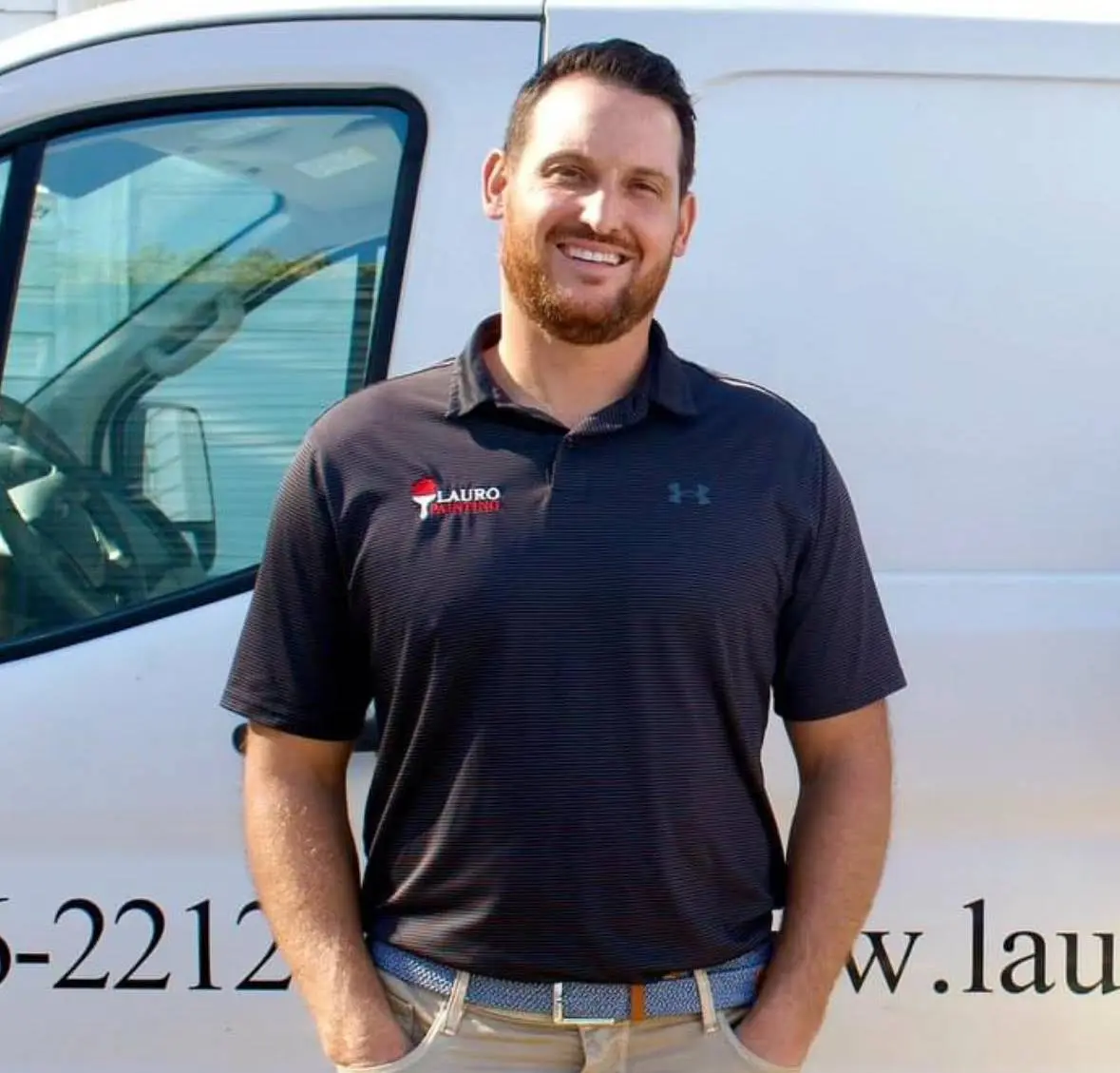 Nick Lauro, owner of Lauro Painting, in front of a company work van.
