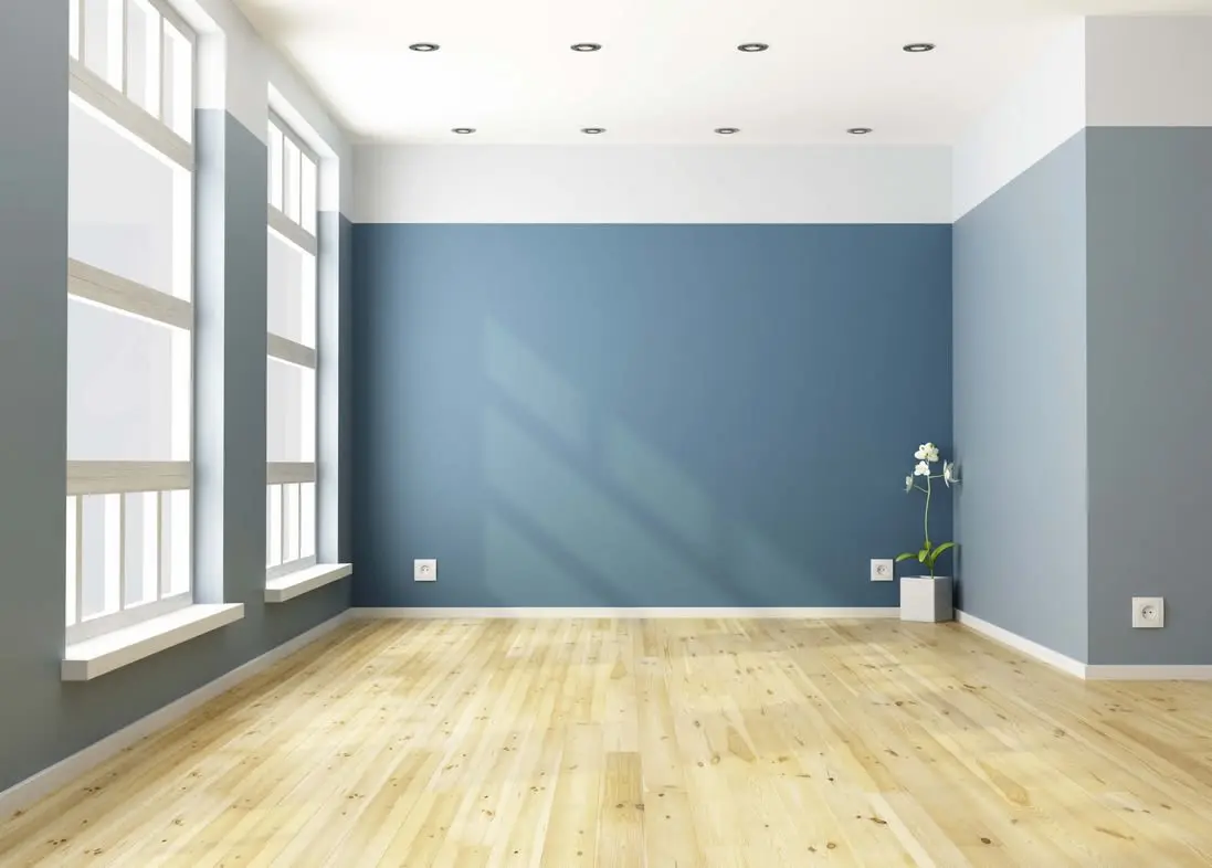 residential-painting-services Example of a blue accent wall paired with light gray walls in a living room.