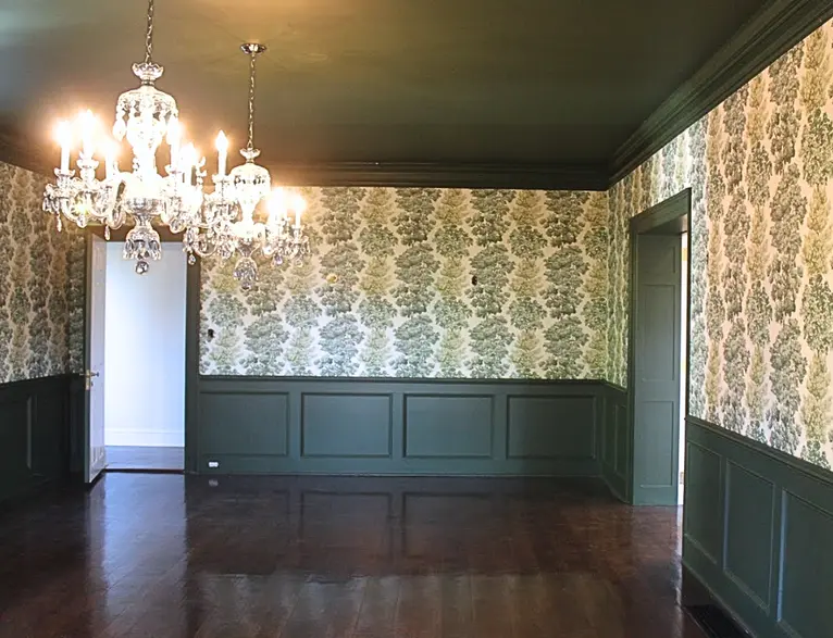 Dining room, freshly redone with tree-pattered wallpaper and dark green wainscoting and a dark green ceiling. Wallpaper and paint completed by Lauro Painting in the Greater Philadelphia area.