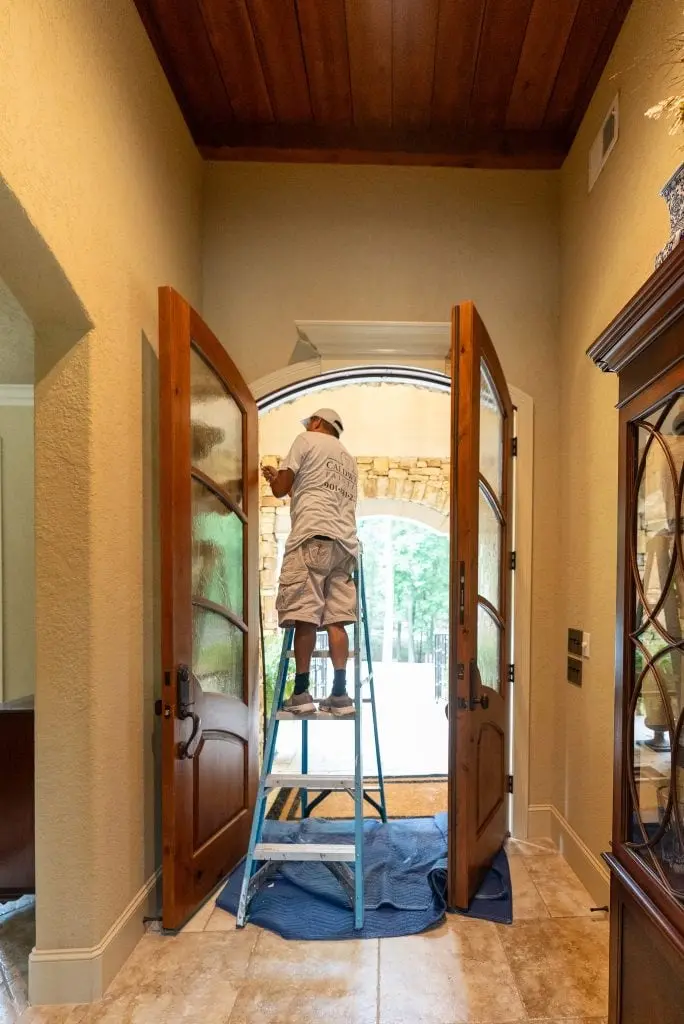 worker completing a project with general finishes exterior 450