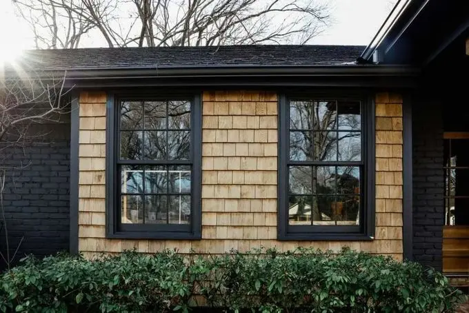 FB_IMG_1674227730563 cedar siding stained with clear general finishes exterior 450 with Benjamin moore Wrought Iron 2124-10 BM with black windows and trim