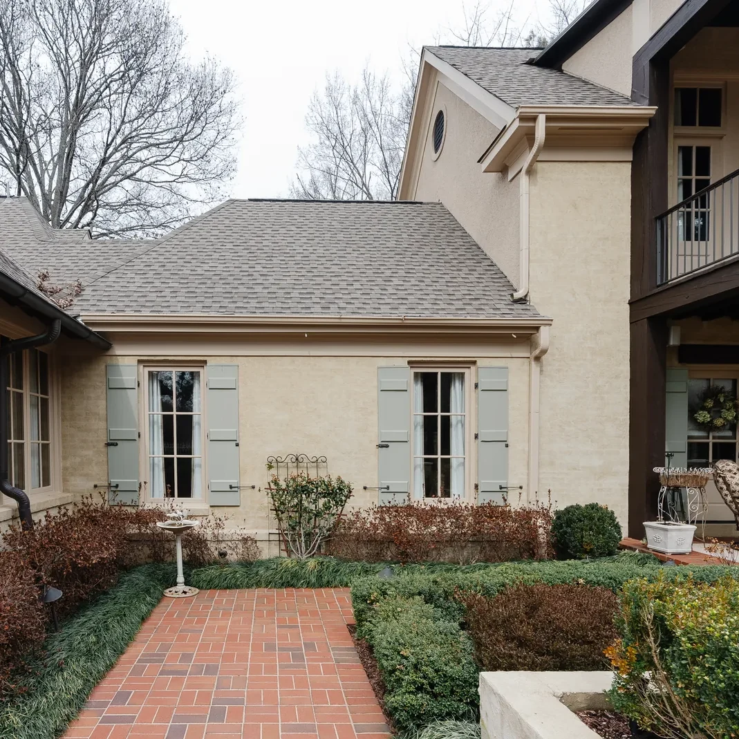 cream-painted-brick-sage-shutters-winter-courtyard