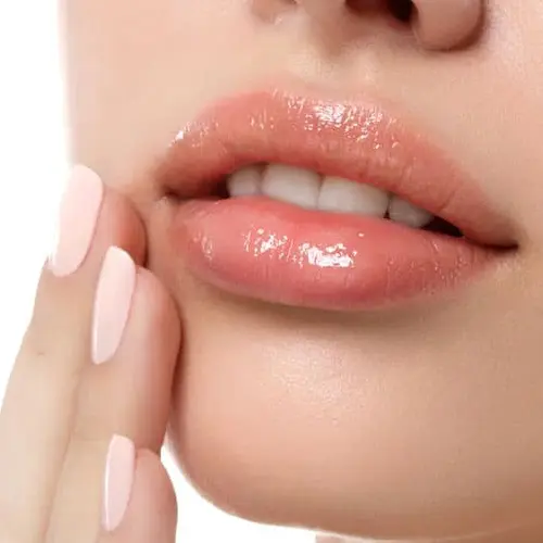 Close-up of a woman's lips with her fingertips resting on her chin