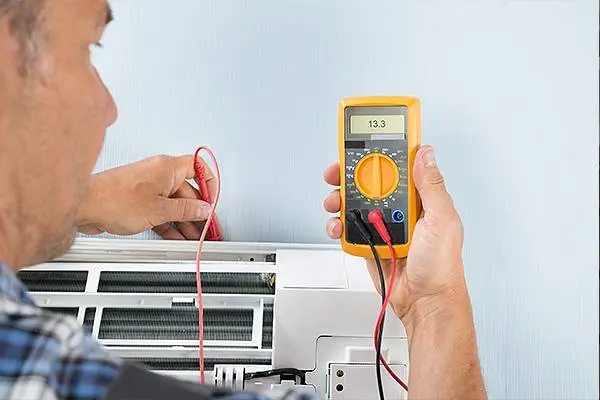 NATE certified HVAC technician servicing an AC unit in Bucks County PA