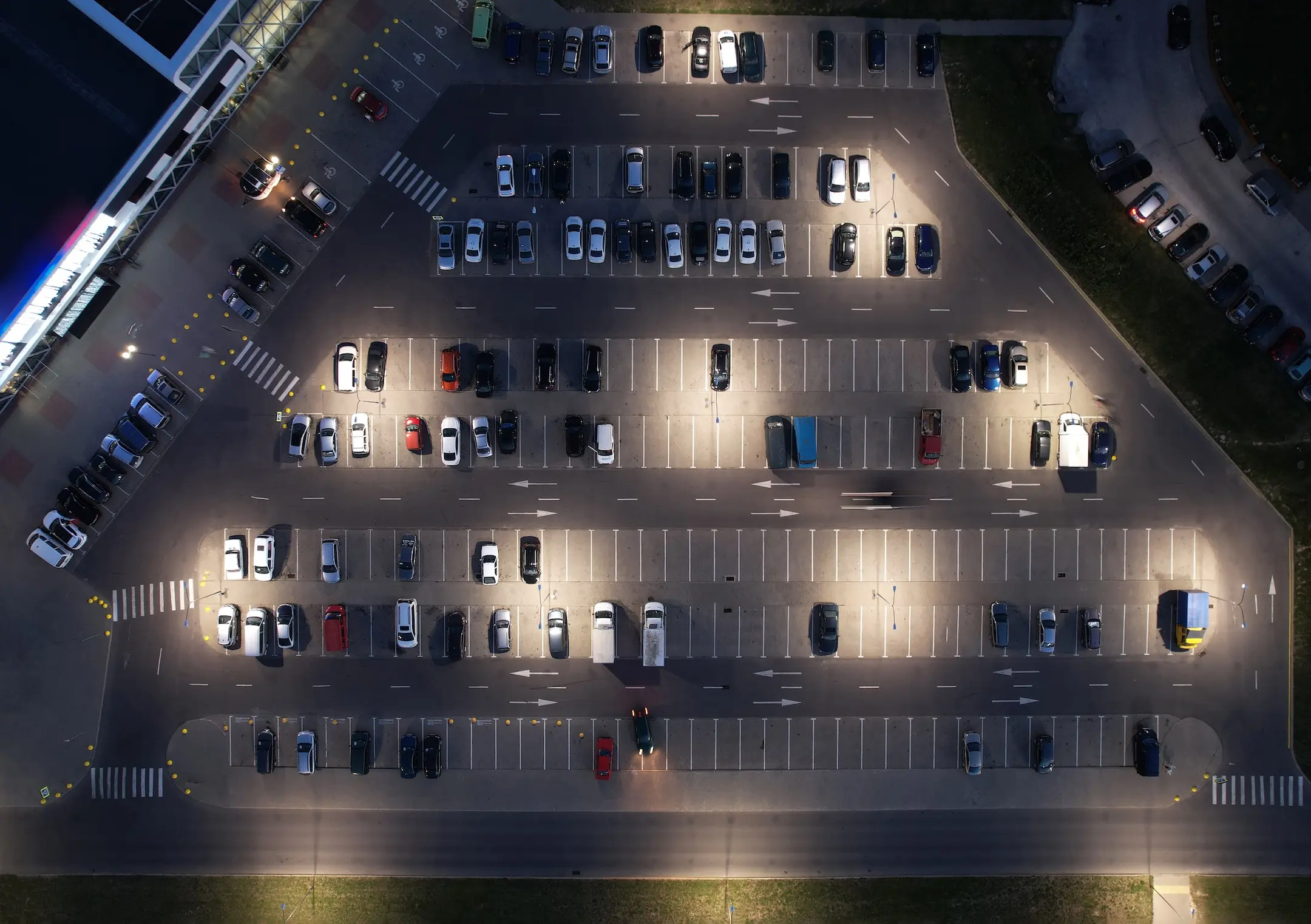 Parking lot with car at night aerial above top view