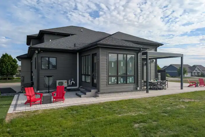 Trusted Landscaping Company Serving Madison, WI 15 Outdoor living space with stylish red chairs and a spacious patio in Madison, WI. Perfect for relaxi.