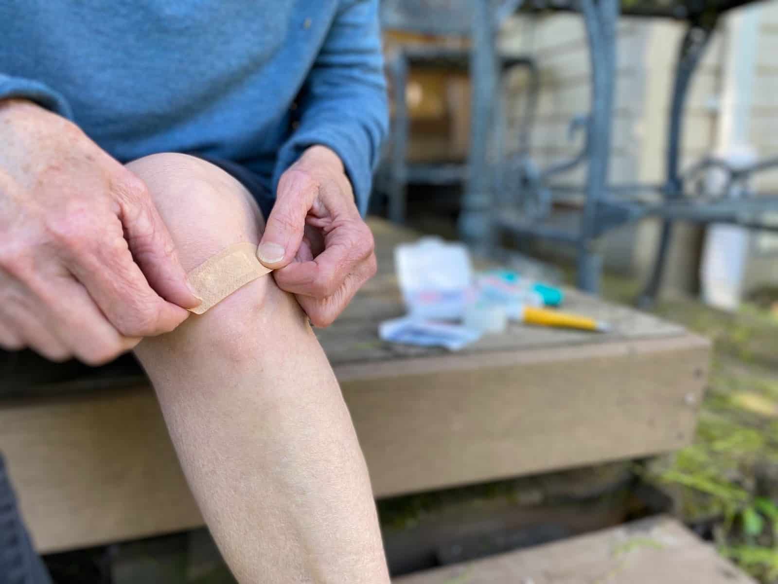 putting bandaid on knee